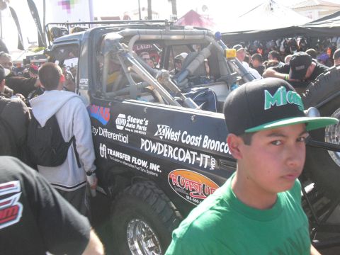 1986 Ford Bronco - Modified 1986 Ford Bronco race truck with extensive roll cage and sponsor decals.
