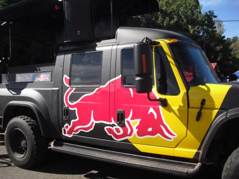 1986 Ford Bronco - This truck is decorated with the Red Bull logo and has large speakers mounted on its roof.