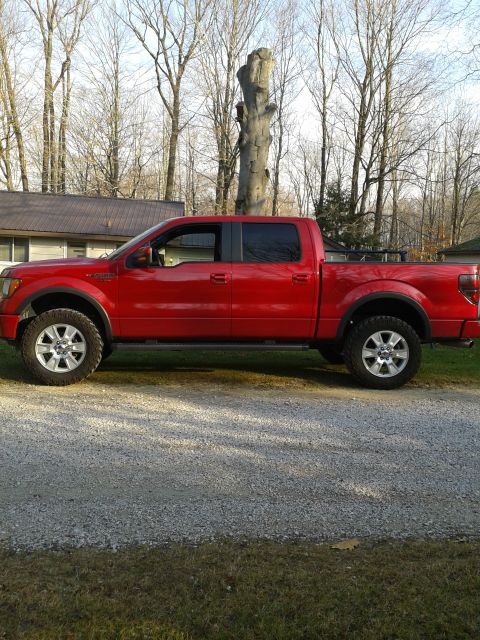 1978 Ford F-150 - Red pickup truck with tinted windows parked outdoors. The body style suggests a model from the late 2000s.