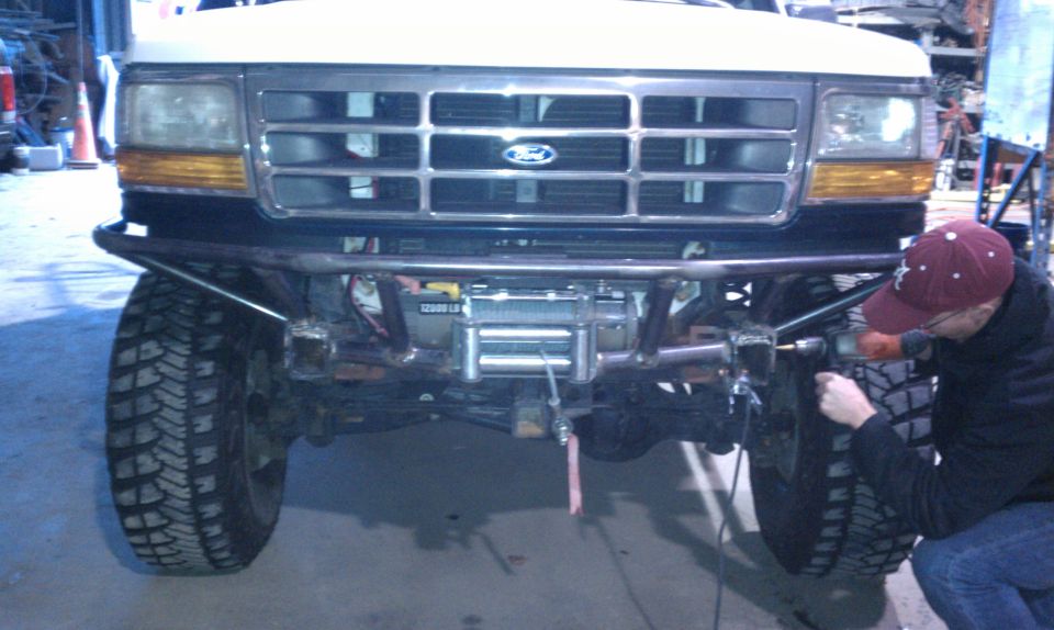 Front view of a 1989 Ford Bronco with a winch and custom bumper