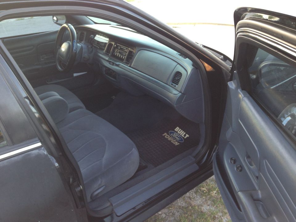2001 Ford Crown Victoria interior showing front seats, dashboard, and floor mats with Ford logo