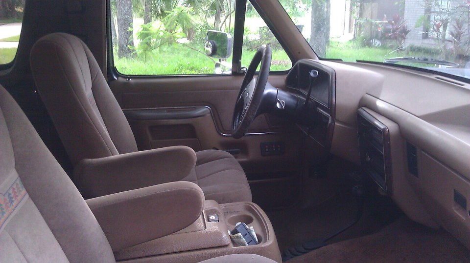 Interior of a 1990 Ford Bronco with bucket seats and a center console
