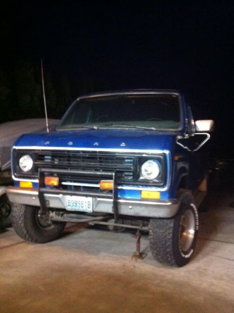 1977 Ford E350 - Front view of a blue 1977 Ford E350 pickup truck with a grille guard and aftermarket wheels.