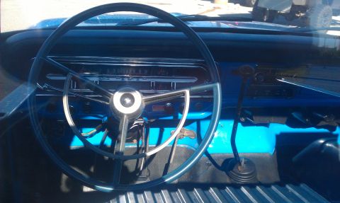1973 Ford F-100 - Interior view of a 1973 Ford F-100 pickup truck with a blue dashboard and steering wheel.