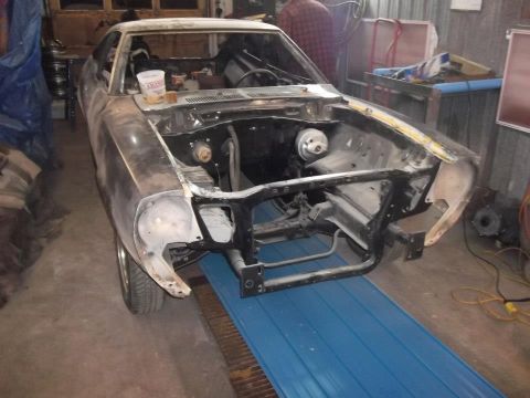 1978 Ford Mustang II - Front view of a 1978 Ford Mustang II undergoing restoration in a workshop.