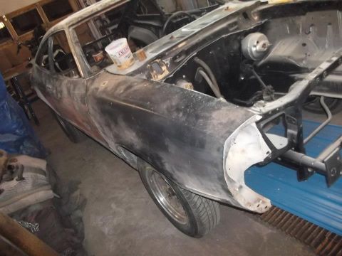 1978 Ford Mustang II - This 1978 Ford Mustang II is in the process of being restored, showing its bodywork and engine bay.