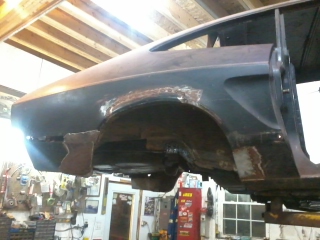1978 Ford Mustang II - This vehicle's rear quarter panel shows significant rust damage and is undergoing repair. The Supermotors.net logo is visible in the lower…