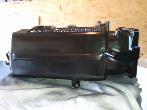1990 Ford Bronco - A black brake master cylinder is shown resting on a cloth, likely before installation or after refurbishment.