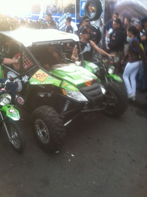 2004 Ford F-150 - A group of off-road vehicles and motorcycles are gathered, with spectators in the background.