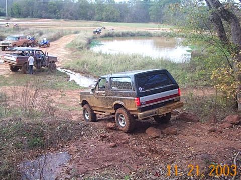 1986 Ford Bronco - Mike climbing down a rocky hill.