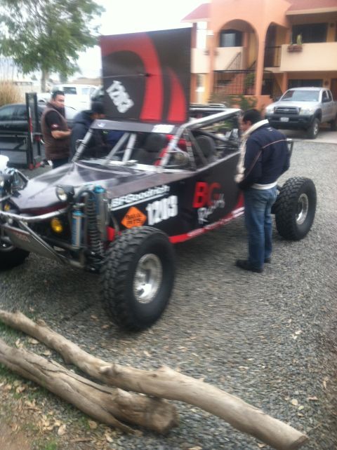 2004 Ford F-150 - This custom off-road buggy features large tires, a roll cage, and a prominent banner with racing graphics and the number 1203.