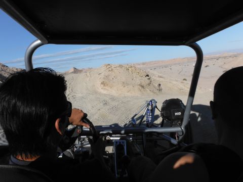 1979 Ford Bronco - View from inside a dune buggy as it navigates a desert trail, with HID lights visible on the roll cage.