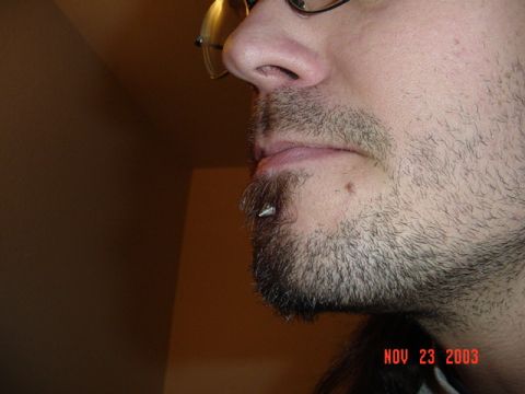 1989 Ford Bronco - A man's face is shown in profile, with a beard and a piercing on his lower lip, along with a date stamp.