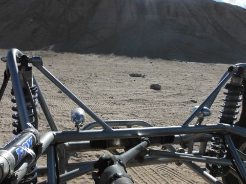 1979 Ford Bronco - The view from the driver's seat of a custom off-road buggy in a sandy, desert environment.