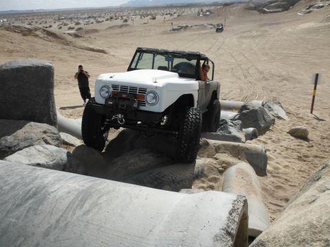 1979 Ford Bronco - This 1979 Ford Bronco is shown navigating a challenging rocky obstacle course in a desert environment.