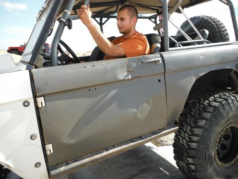 1979 Ford Bronco - A man sits in a modified Ford Bronco, ready for off-road adventure.