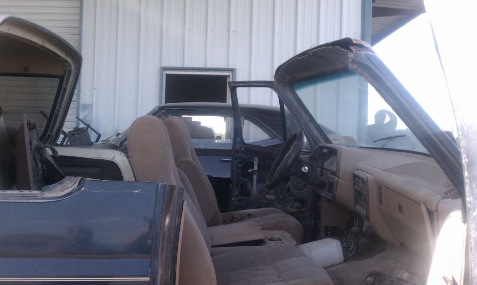 1988 Ford Bronco interior with seats and dashboard visible, doors removed