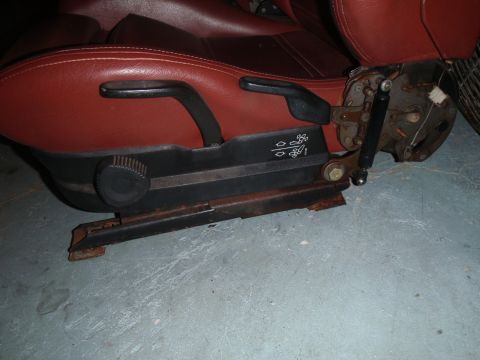 1991 BMW 3 Series - Close-up view of a red leather car seat, showing its interior components and adjustment mechanisms.