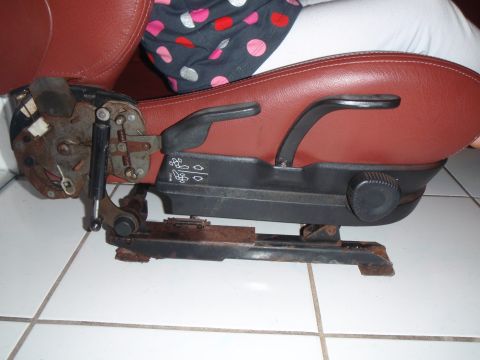 1991 BMW 3 Series - Close-up of a car seat's mechanical base, showing adjustment levers and rails.