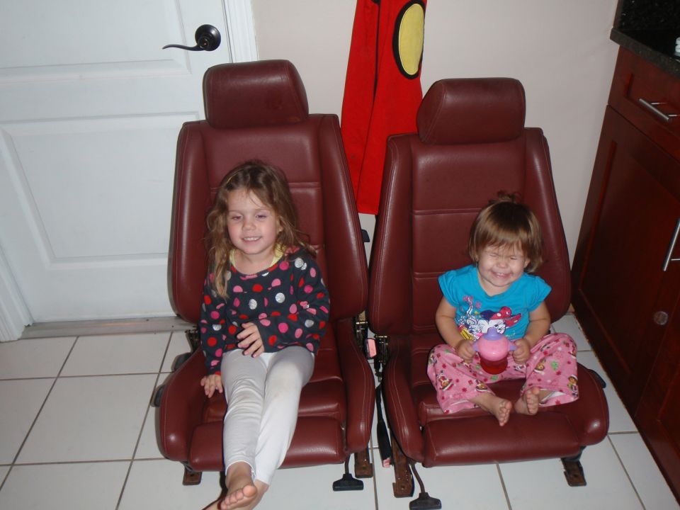 Two car seats with children sitting in them