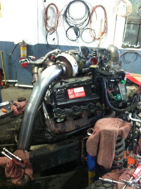 2006 Ford F-250 - Diesel engine with turbocharger and exhaust piping, appears to be out of a vehicle for service.