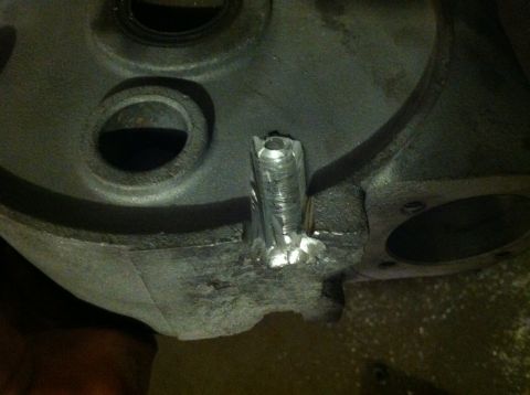 1991 Ford F-250 - Close-up of a metal engine component with a newly welded piece attached.