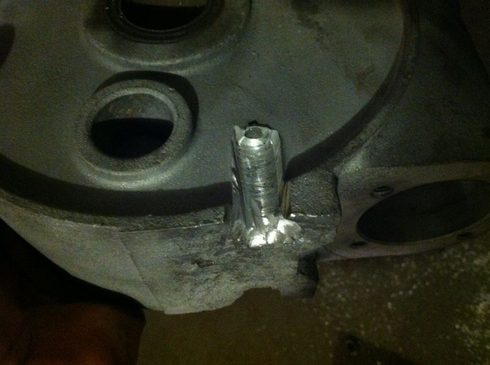 Engine part with a welded metal extension. Supermotors.net logo visible