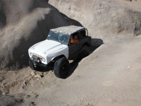 1979 Ford Bronco - This modified off-road vehicle navigates a challenging rocky terrain.