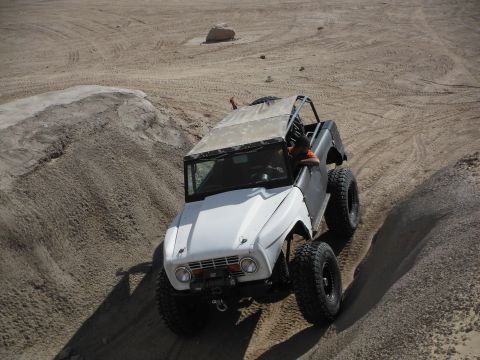 1979 Ford Bronco - This 1979 Ford Bronco navigates a sandy incline, its off-road capabilities with a two-tone paint scheme and tires.