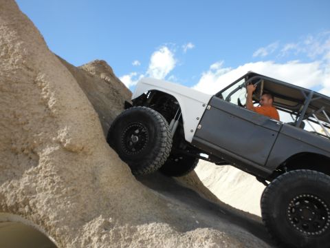 1979 Ford Bronco - This modified 1979 Ford Bronco navigates a steep, rocky terrain, its off-road capabilities.