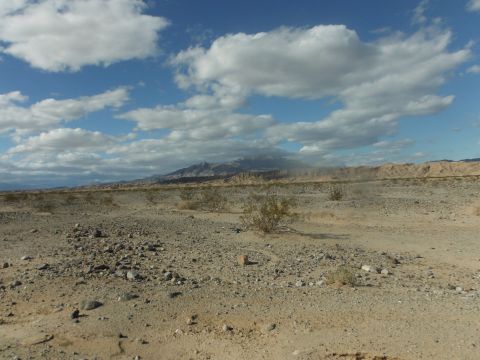1979 Ford Bronco - Desert scene with mountains under a cloudy sky. Watermark visible in the lower right corner.