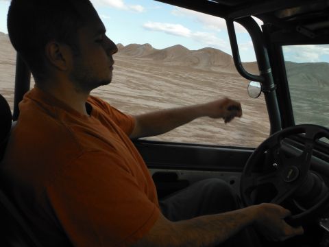 1979 Ford Bronco - Driving a 1979 Ford Bronco through the desert, with mountains in the background.