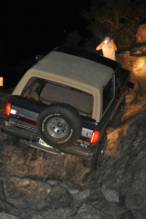 1991 Ford Bronco - This 1991 Ford Bronco navigates a challenging rocky path at night.