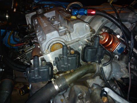 1995 Ford Probe - Engine bay detail showing distributors and a fuel pressure regulator.