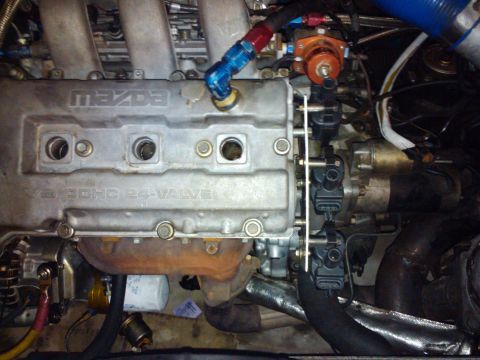 1995 Ford Probe - The engine block clearly shows the 'MAZDA' branding and V6 DOHC 24-VALVE designation.
