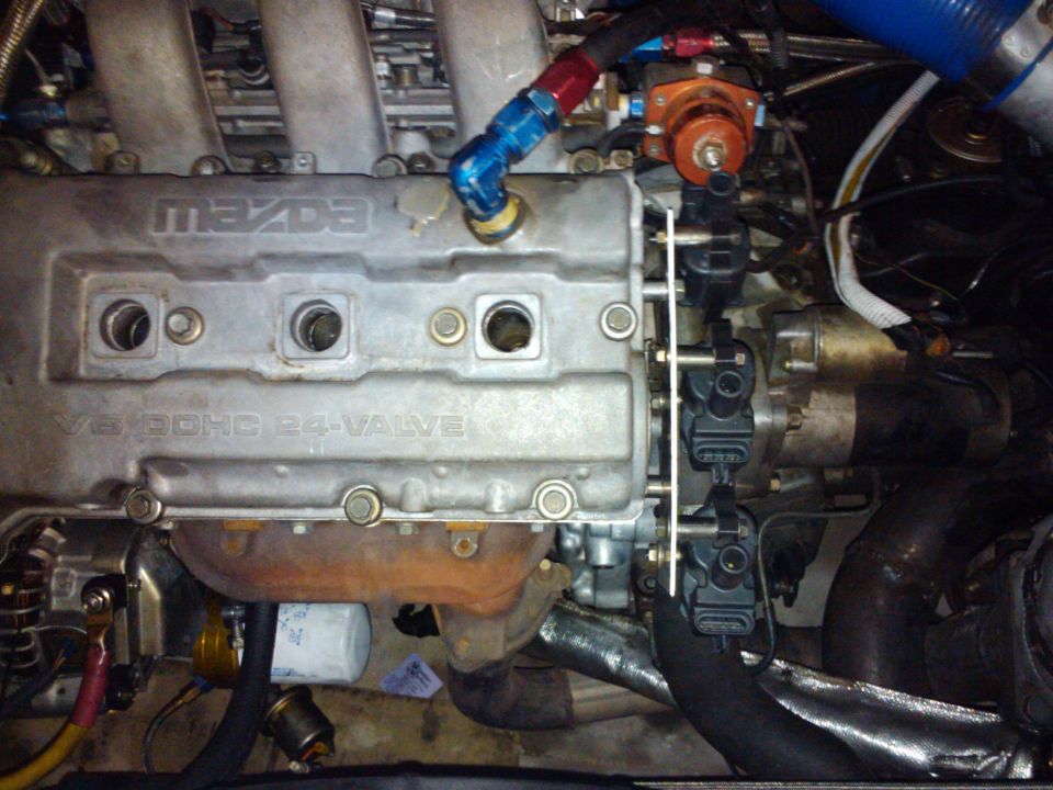 Close-up of a Mazda V6 DOHC 24-valve engine with fuel lines and ignition coils