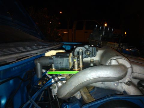 1995 Ford Probe - Close-up view of an engine bay, focusing on ignition coils and intake manifold components.