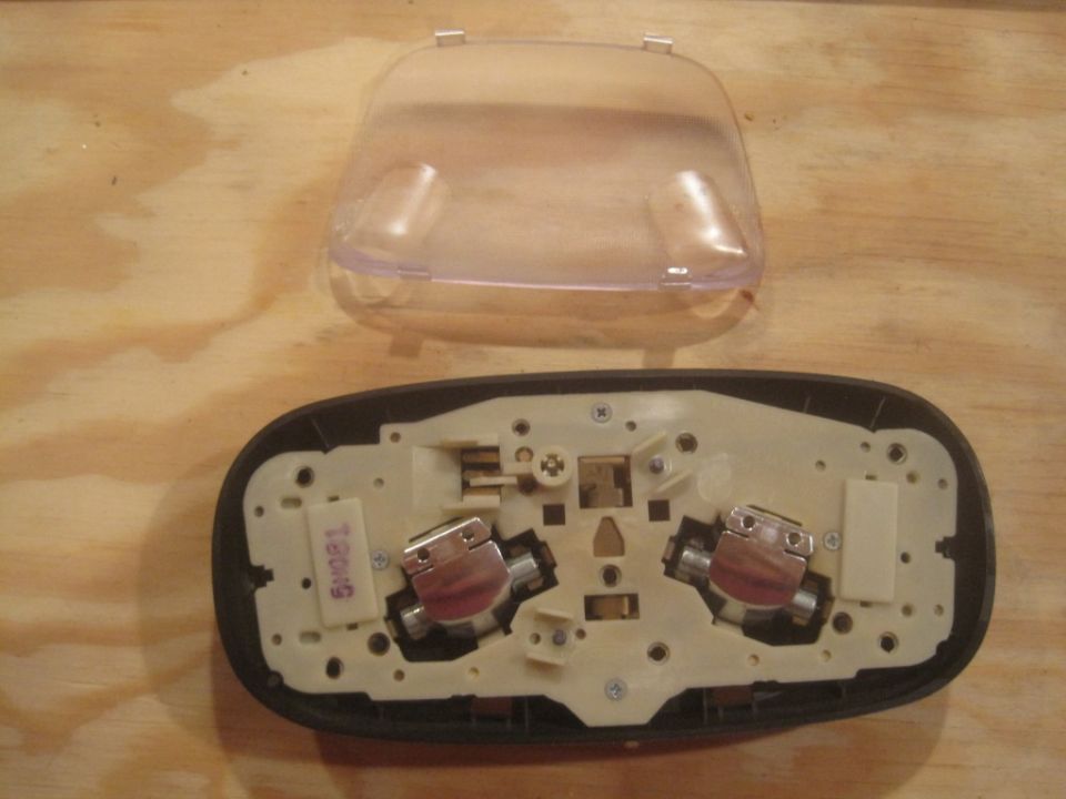 Overhead dome light assembly with clear lens removed, showing bulb sockets and wiring
