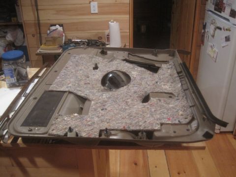 1993 Ford Bronco - This is a tan door panel, likely from a truck or SUV, with its insulation and speaker grille removed.