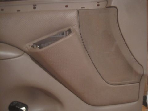 1993 Ford Bronco - Interior door panel detail, showing textured material and a speaker grille.