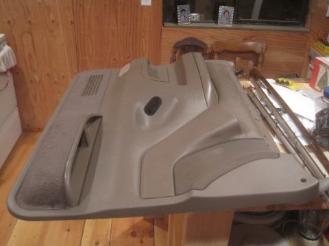 1993 Ford Bronco - This is a tan interior door panel, likely for a truck or SUV, shown from the inside.