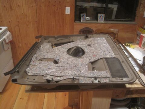 1993 Ford Bronco - This is a car door panel with insulation and speaker cutout, likely for a Ford Bronco.