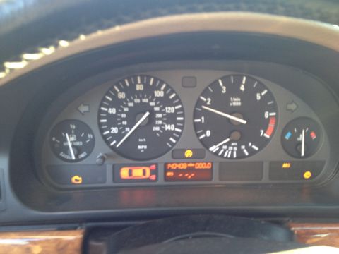 1999 BMW 5 Series - Dashboard view of a 1999 BMW 5 Series, showing illuminated gauges and warning lights.