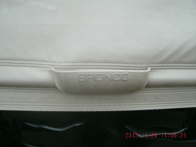 Gray vinyl cargo cover with BRONCO embossed molded pull handle