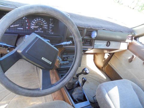 1985 Toyota Pickup/SR5 - Interior view of a 1985 Toyota Pickup/SR5, highlighting the dashboard and manual transmission.