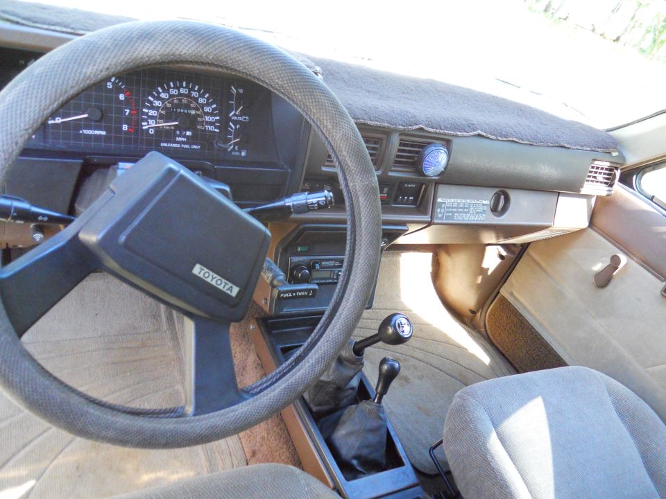1985 Toyota Pickup/SR5 interior showing dashboard, steering wheel, gear shifter, and seats