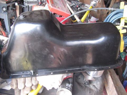 1996 Ford Bronco - A black oil pan is shown, likely a replacement part for a vehicle.