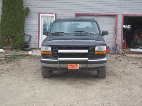 1996 Ford Bronco - This Ford F-150 pickup truck is parked in front of a garage with a bull bar and an elementary school license plate.