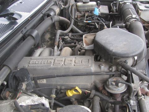 1996 Ford Bronco - Close-up view of a Ford 5.0L V8 engine, showing various components and labeling.