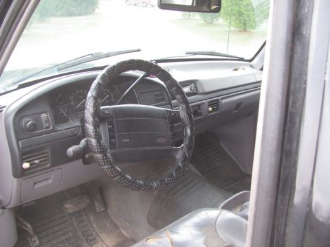 1996 Ford Bronco - Interior of a 1992 Ford F-Series truck, showing the dashboard, steering wheel, and floor mats.